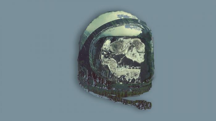 Astronaut helmet with skull and landscape overlay
