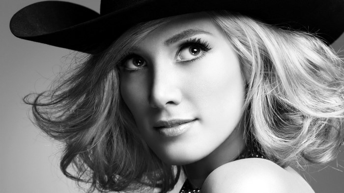 Monochrome portrait of a woman wearing a black hat
