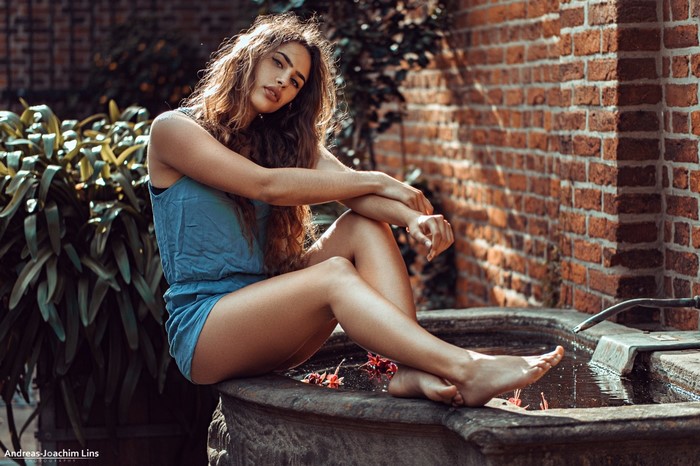 Woman sitting by a fountain