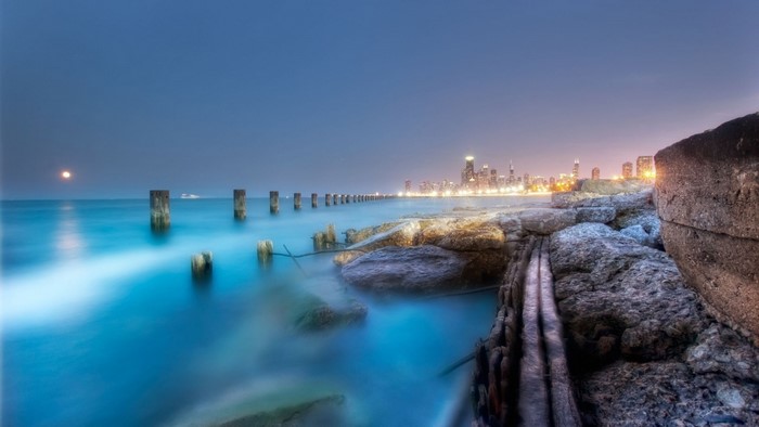 Chicago skyline at dusk over Lake Michigan with old pilings