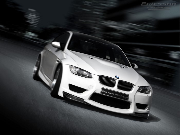 White BMW M4 Concept car driving on a blurred road