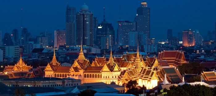 Bangkok cityscape at dusk with Grand Palace illuminated