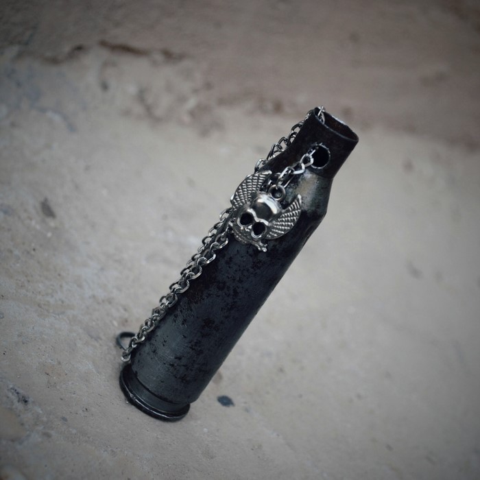 Bullet casing with skull and chain necklace