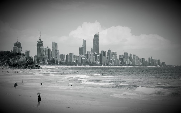 Monochrome cityscape with beach and ocean waves