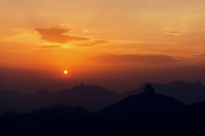 Sunset over silhouetted mountains