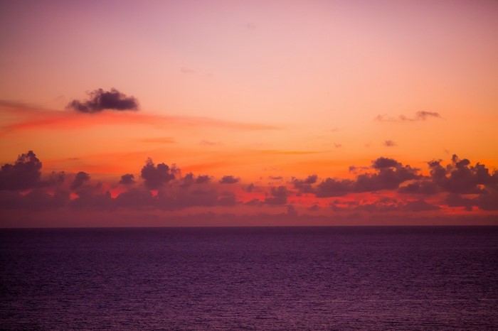Sunset over the ocean with clouds