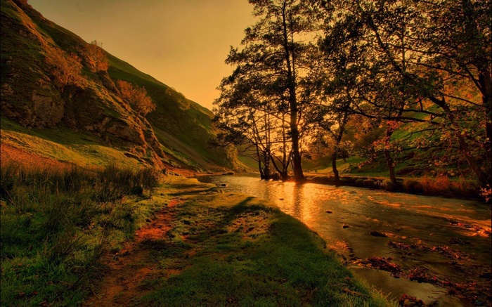 River flowing through a valley at sunset