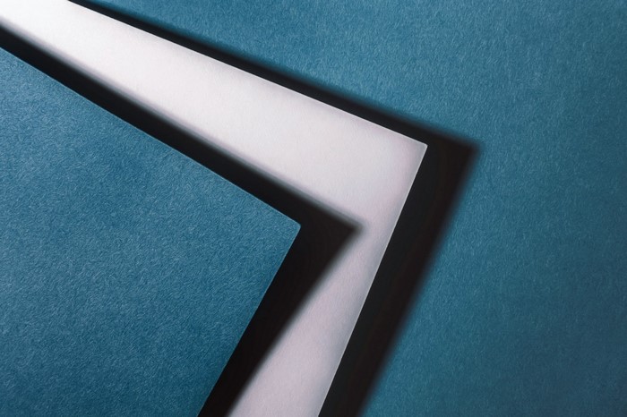 Abstract geometric shapes with shadows on blue background