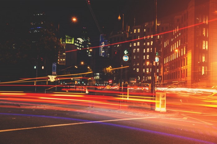 City street at night with light trails from traffic