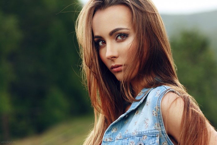 Portrait of a Woman with Long Hair in Denim Vest
