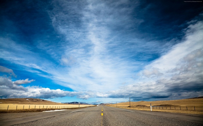 Road under a cloudy sky