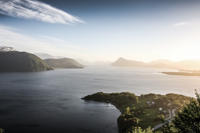 Sunlight over a Fjord in Norway with Mountains