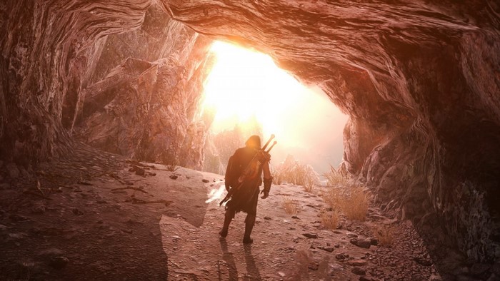 Man with swords exiting a cave into sunlight
