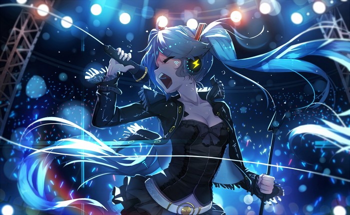 Hatsune Miku performing on stage with headphones and microphone