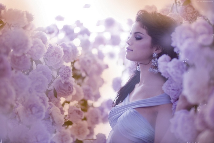 Selena Gomez surrounded by purple flowers