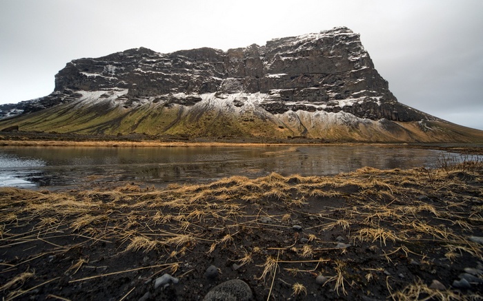 Mountain landscape with a lake and dry grass