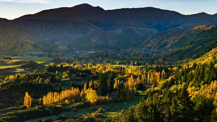Autumn valley with mountains and village