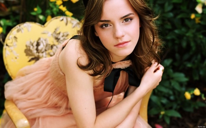 Emma Watson sitting on a yellow chair