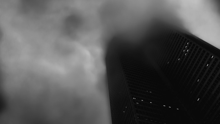 Monochrome photography of a skyscraper in mist