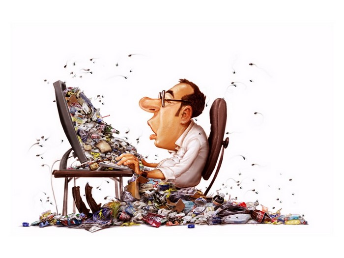 Man sitting at a computer surrounded by trash and flies