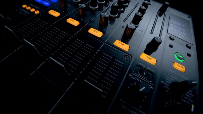 DJ mixer with illuminated buttons and faders
