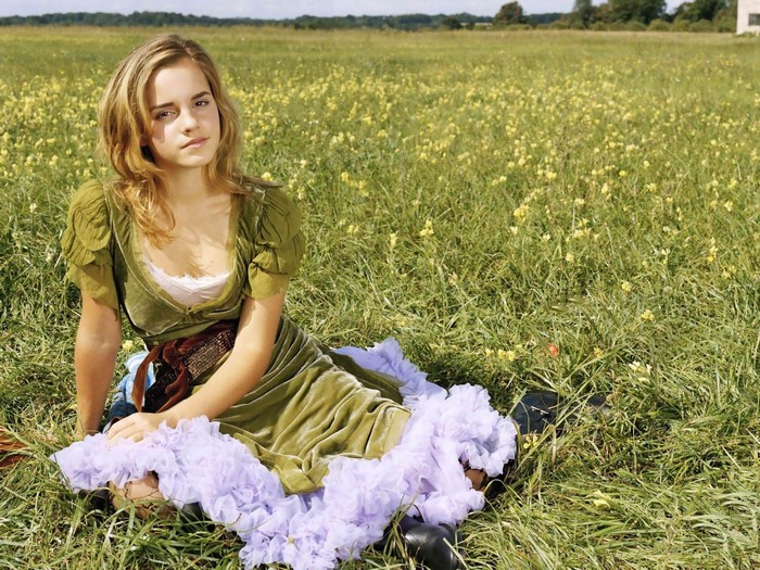 Emma Watson Sitting in a Green Field with Flowers