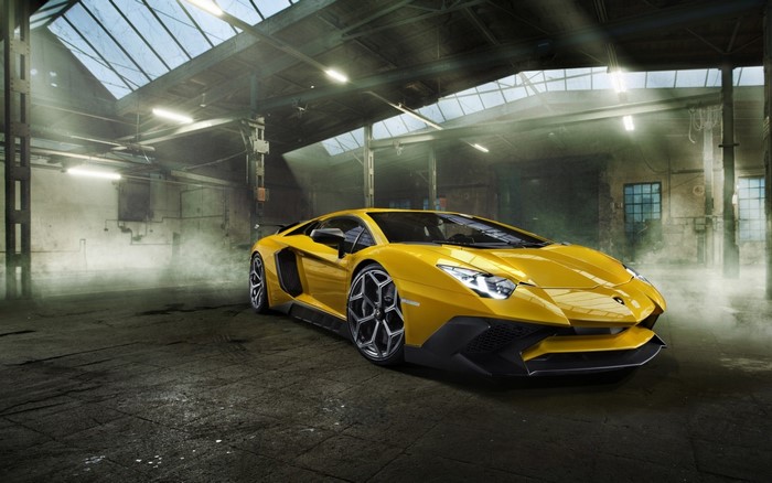 Yellow Lamborghini Aventador in a dusty garage