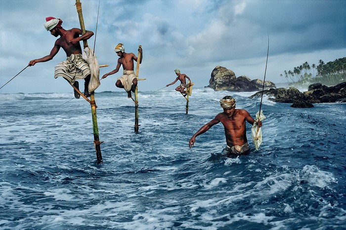 Stilt fishermen fishing in the sea during a storm