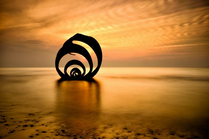 Sculpture in the sea at sunset