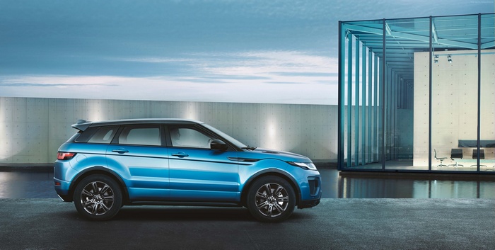 Blue Range Rover Evoque parked near modern building