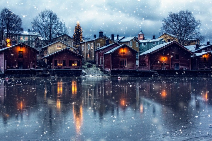 Winter village with snow and reflections