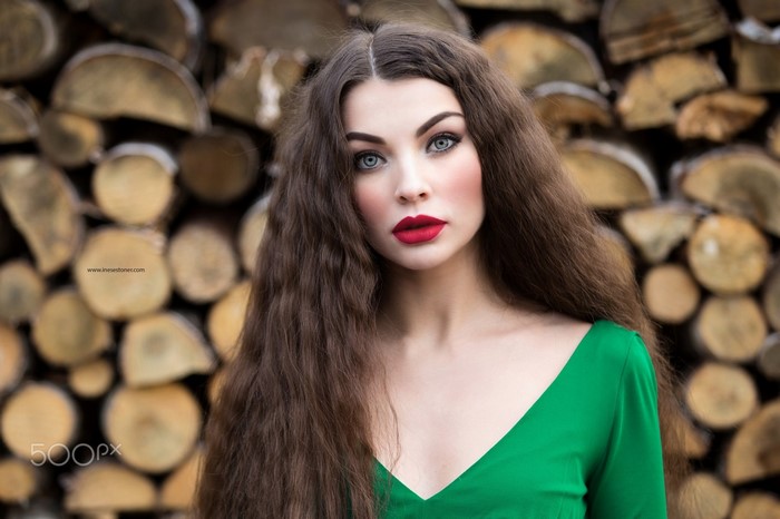 Woman with long brown hair and red lipstick
