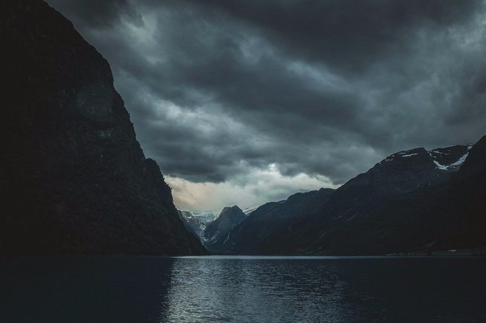 Dark Fjord with Mountains and Clouds