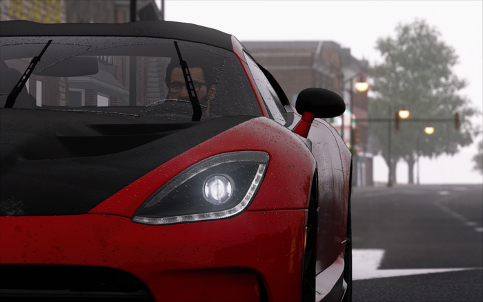 Red Dodge Viper driving on a rainy city street