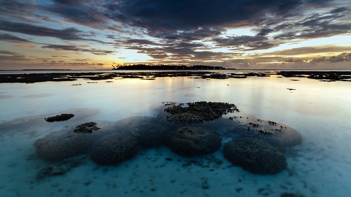 Sunset over the sea with coral reefs