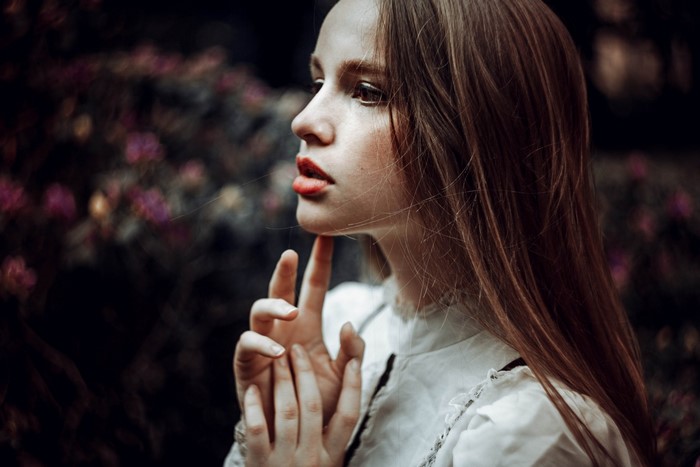 Woman with long brown hair and red lipstick