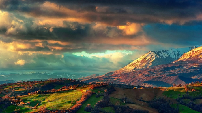 Mountain landscape with rolling hills and dramatic clouds