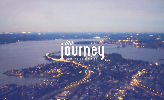 The journey not the destination quote over cityscape at dusk