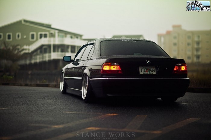 Black lowered BMW E38 sedan with Stanceworks logo