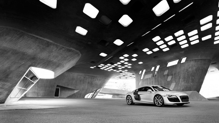 White Audi R8 parked in a modern concrete structure