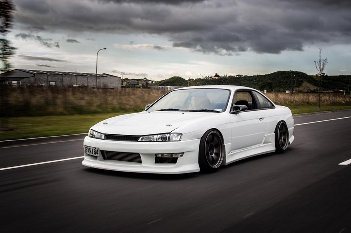 White Nissan 200SX S14 sports car on road