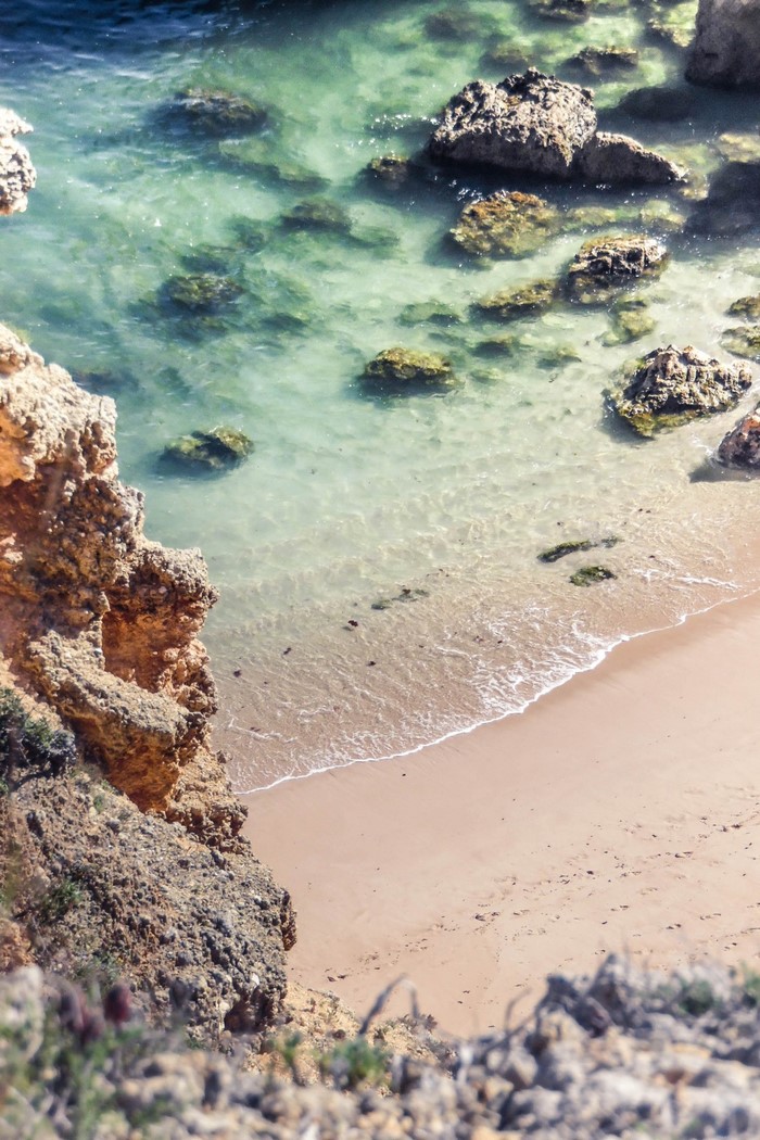 Rocky coast with clear turquoise water and sandy beach