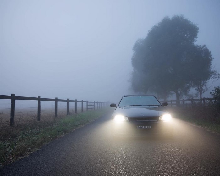 Car driving on a foggy road