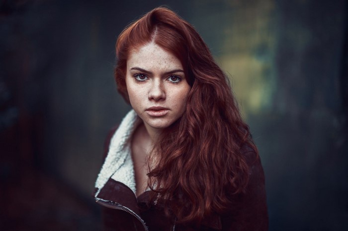 Redhead woman with freckles wearing a jacket
