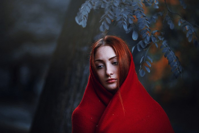 Redhead woman wrapped in red cloth outdoors