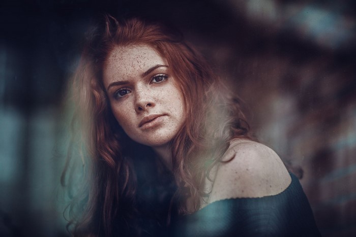 Redhead woman with freckles looking at viewer