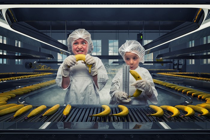 Children in factory with bananas
