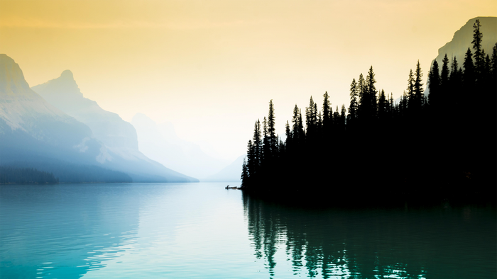 Serene Morning at Lake Maligne with Misty Mountains