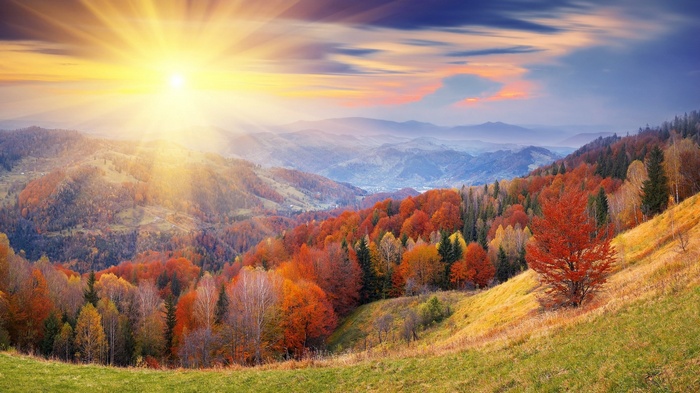 Autumn mountain landscape with sun rays
