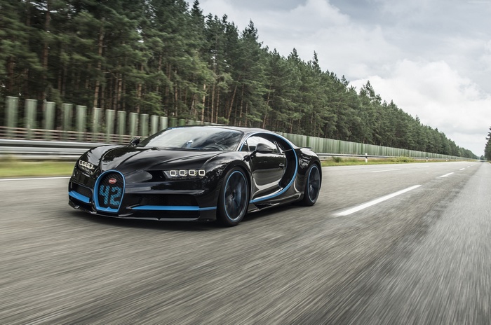 Black Bugatti Chiron with blue accents on a road